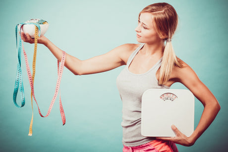 Girl with scales measuring tapes. Weight loss.